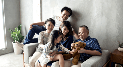multi-generational family sitting on one big chair