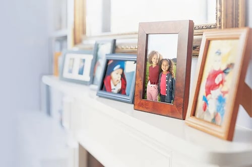 Framed family photos on mantle in page
