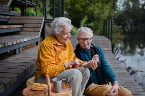 Senior couple talking cottage dock
