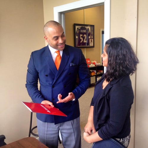 Agent Adam and customer working together wearing professional attire