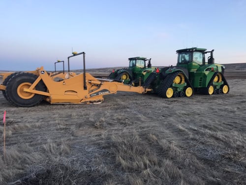 John Deere Tractors parked at a construction job site