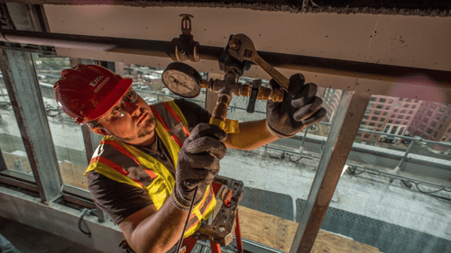 employee installing a fire sprinkler system