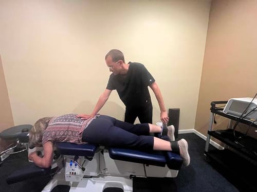 Dr. Gage Kirstein adjusting a patient