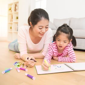 mother and child drawing in a notebook