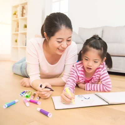 mother and child drawing in a notebook