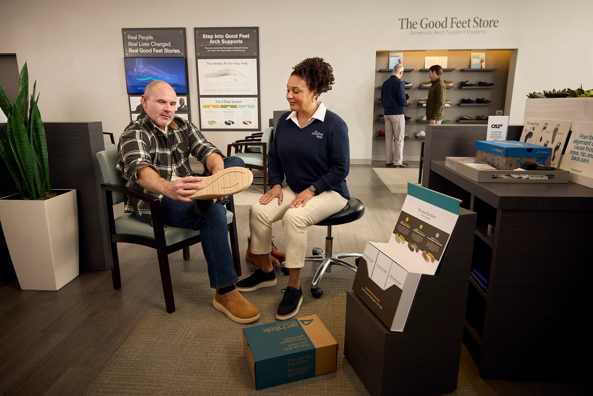 Arch Support Specialist evaluates customers arches during personalized fitting at The Good Feet Store