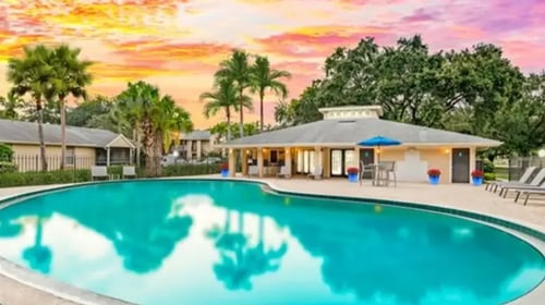 Building interior with pool at Aqua Bay Apartments in Naples, FL 34116