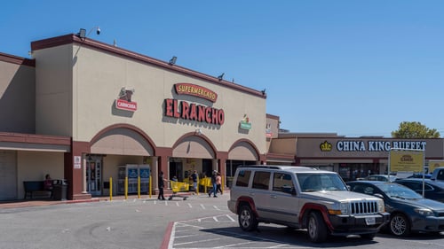 White jeep in front of El Rancho Supermarket