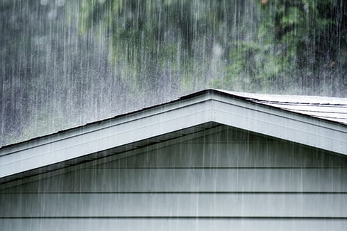 Heavy rain falls on a roof during a powerful storm system in Horry County, SC.
