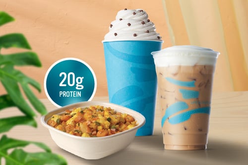 Two coffee drinks and a breakfast bowl with eggs and veggies