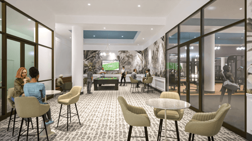 An indoor view of a lounge area with a television screen on the wall, billiards table, and seating with tables