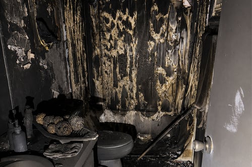 Extensive fire and smoke damage is visible in a bathroom of a home in Murrells Inlet