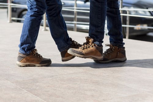 clos up feet of two men wearing work boots