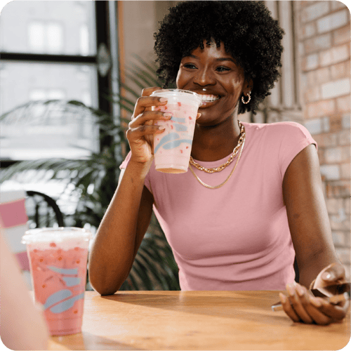 Woman smiling and enjoying a Refresher