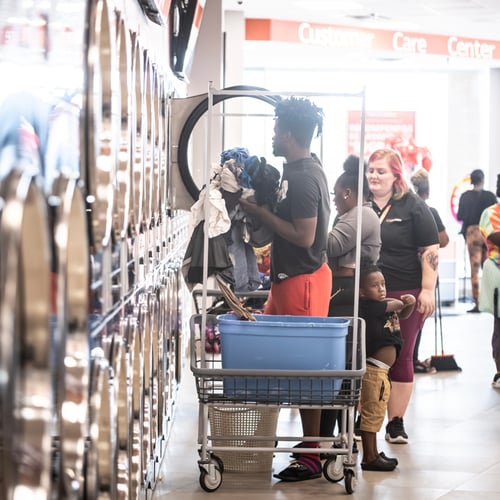 Customers using laundry carts inside Speed Queen Laundry