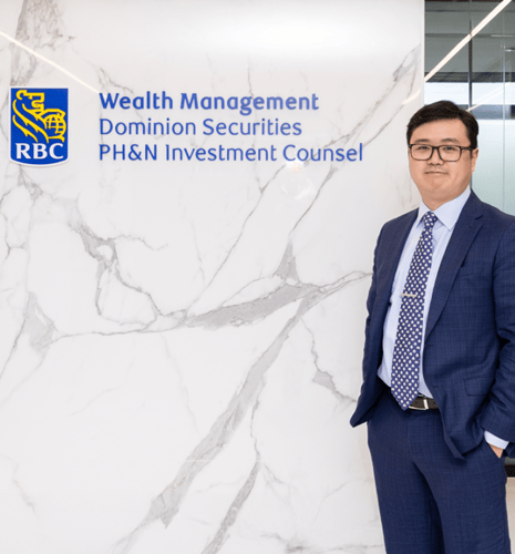 Lester Shao standing beside the RBC Wealth Management sign.