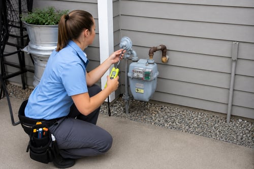 Plumber testing for a gas leak