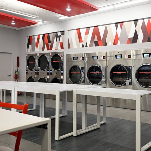 Modern Speed Queen Laundry with washers, dryers and folding tables