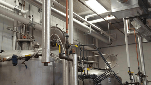 silver industrial pipes that have been insulated
