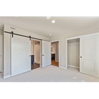 Bedroom with sliding door to bathroom at Nuovo Apartments, Bellevue, 98005