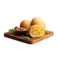 A kolache filled with scrambled eggs mixed with ground ham, picante sauce, cheese and jalapeños