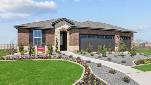 new home with brick exterior and beautiful yard landscaping