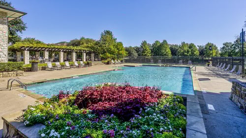 Resort-style swimming pool on a sunny day at Cypress Lake at Stonebriar Apartments, Frisco, Texas