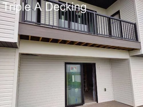 under deck with railing and concrete patio below