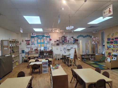 Colorful classroom with art supplies, learning centers, and play areas designed for early childhood education.