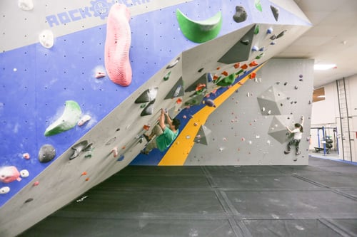 A man bouldering on a very steep wall at Central Rock Gym Framingham.