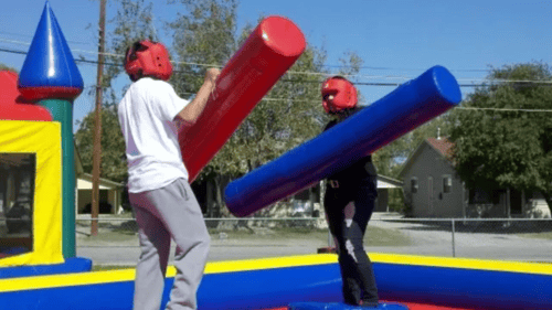 two kids playing on an inflatable interactive area