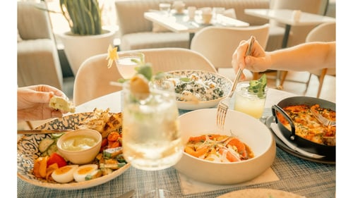 Food and beverage spread at Anise featuring breakfast, lunch, and cocktails
