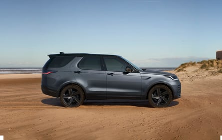 Eiger Grey Discovery parked on a driveway outside a white suburban house