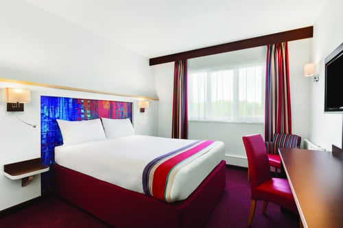 Bedroom with double bed, desk and TV
