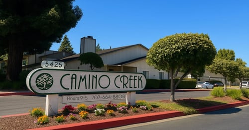 A sign for Camino Creek with a phone number and hours of operation