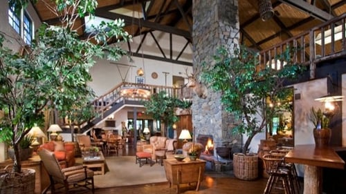 the lobby of a clubhouse with a large living room and a staircase at The Aspens South Coast in South Coast Metro, CA, 92704