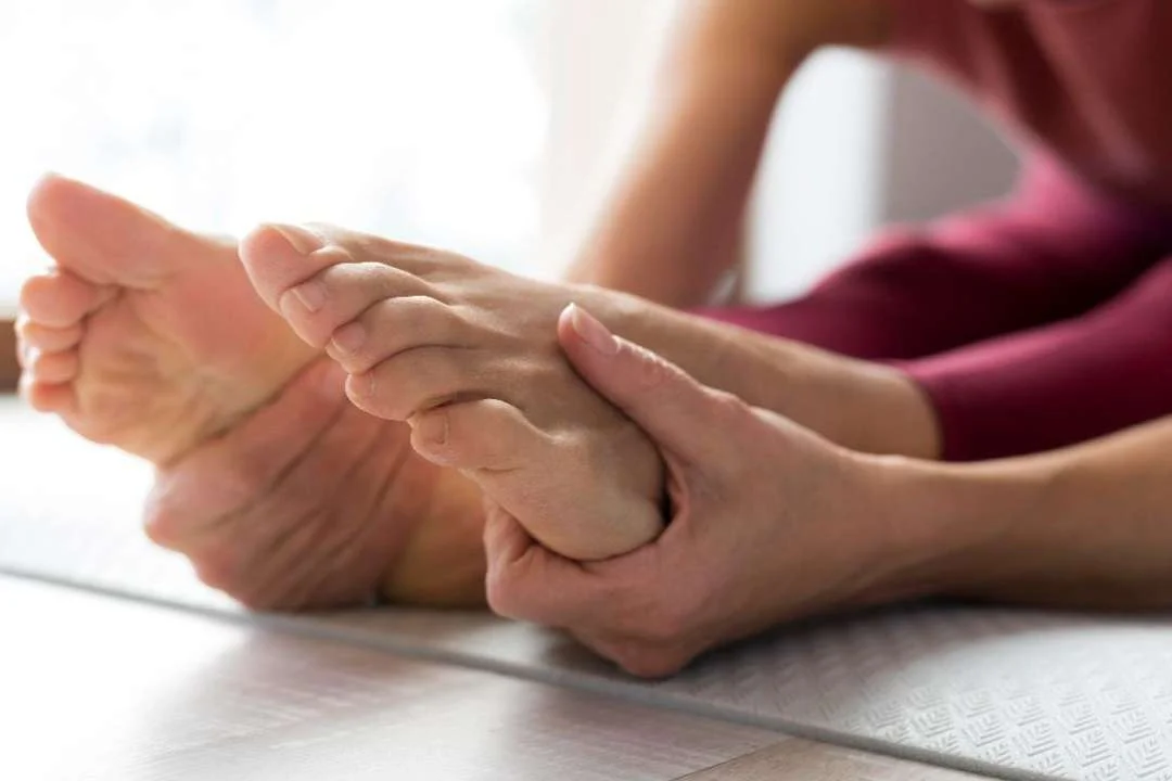Woman stretching her feet to relieve morning stiffness