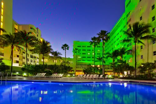 The Holiday Inn Miami Beach-Oceanfront exterior seen at night.