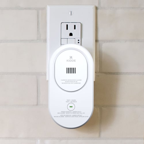 A Carbon monoxide alarm is plugged into a wall outlet.