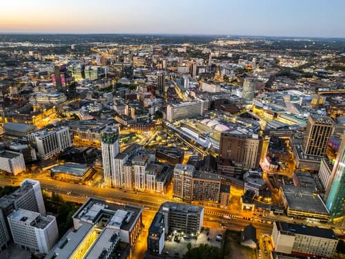Birmingham Buy-to-Let Property Investment - STOCK Birmingham, United Kingdom Aerial view over the city centre by night, rail station