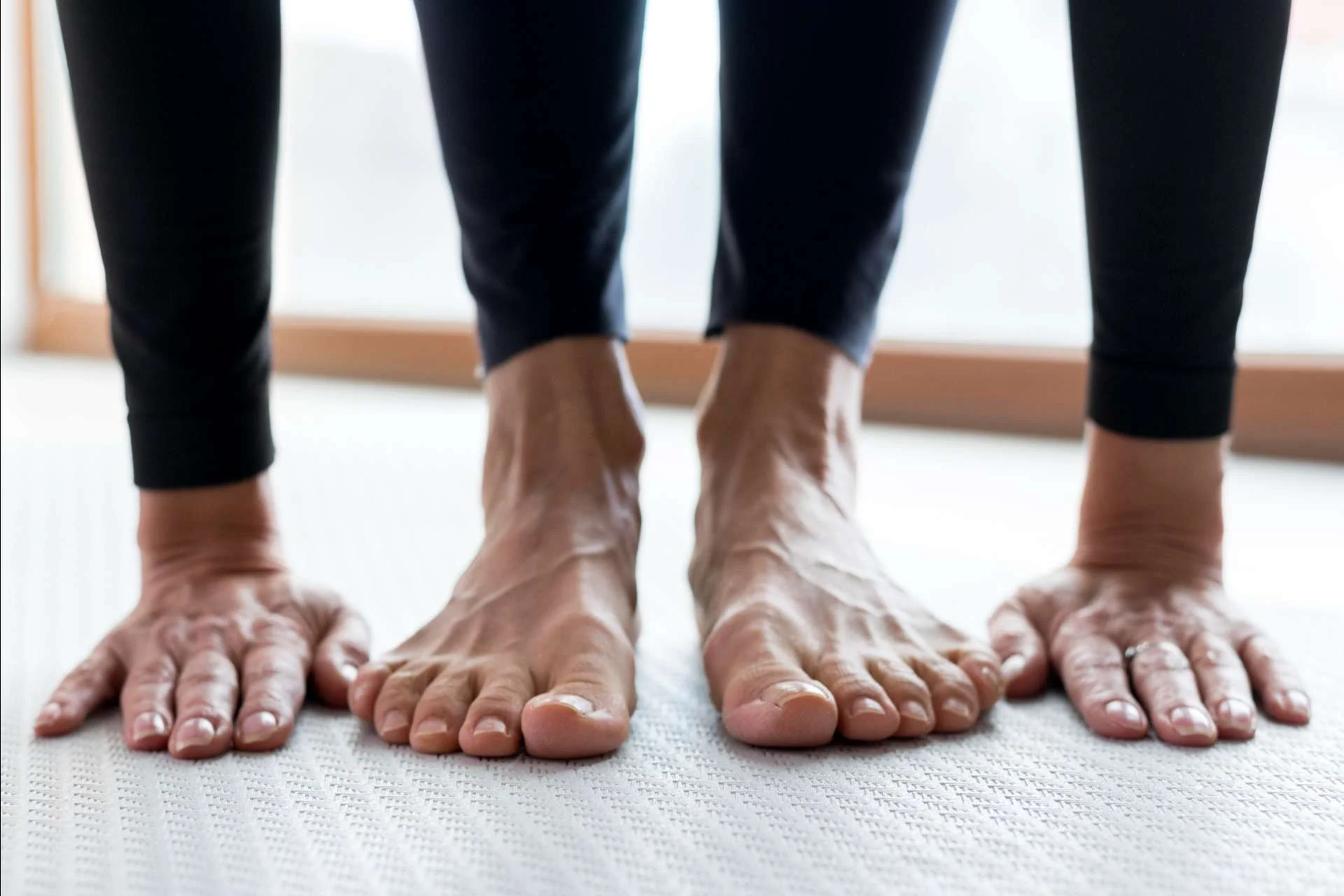 older person stretching by doing a forward bend