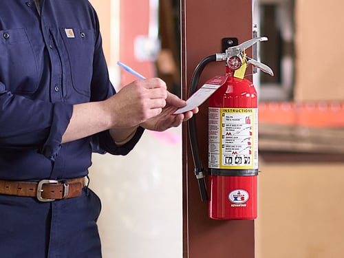 Person checking the fire extinguisher