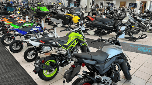 wide variety of bikes and snowmobiles on a sales floor