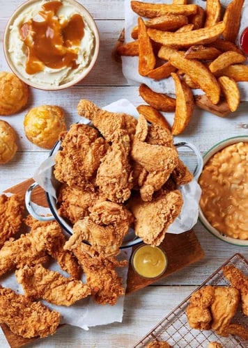 A delicious spread featuring crispy fried chicken, golden fries, and an assortment of other appetizing dishes.