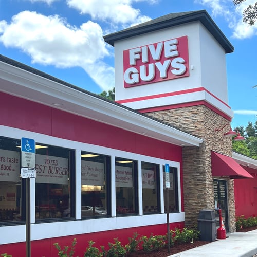 Exterior photograph of the Five Guys restaurant at 898 Saxon Boulevard in Orange City Florida.