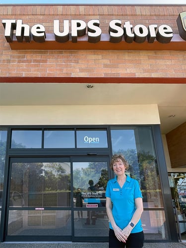 The UPS Store owner standing outside, in front of her store.