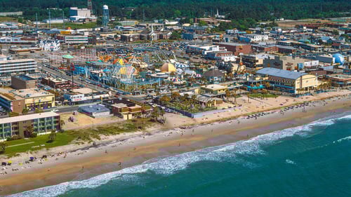 ariel of beach front with homes lining shore