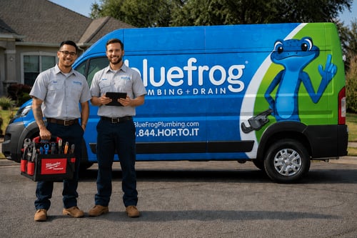 plumbers standing outside of their branded vehicle