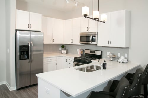 A kitchen with white cabinets and a counter top at Residences at 1700 Logo, Minnetonka, MN 55305