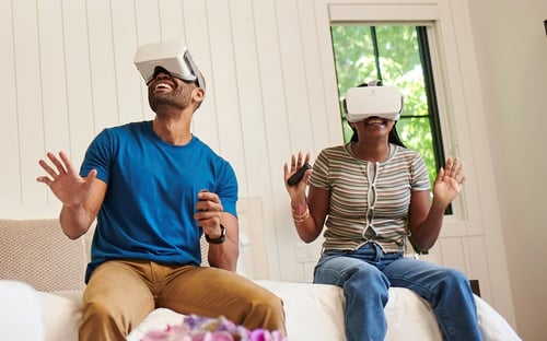 Man and girl wearing VR headsets